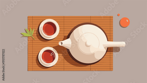Overhead view of a traditional tea service set on a wooden tray with a small green bamboo leaf for decoration.
