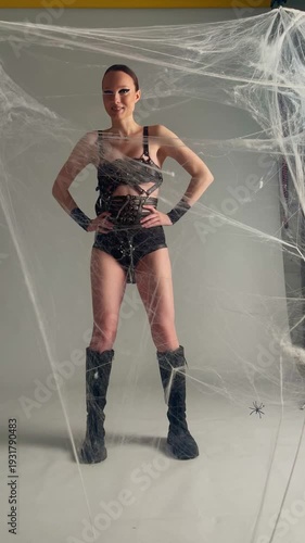 Woman in Gothic Leather Posing in Spiderweb