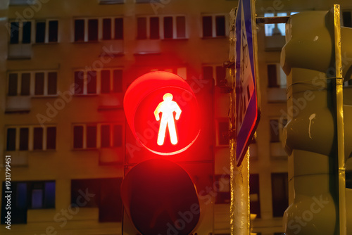Red traffic light against the backdrop of an evening city.