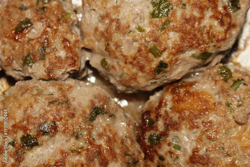 A delicious selection of homemade meatballs with fresh herbs on a plate for family dinner
