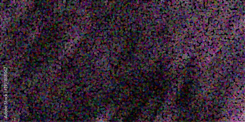 Abstract pointillism background with a dark backdrop and a multitude of small colorful dots in shades of purple red blue and green creating a textured effect