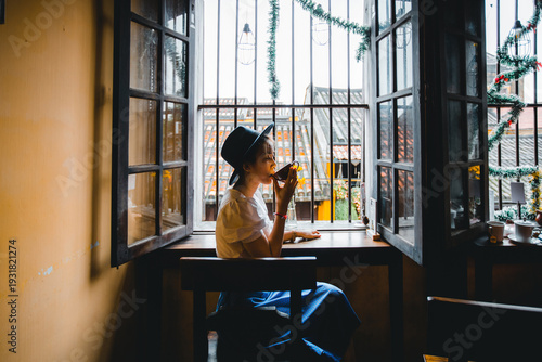 Coffee. Beautiful Girl Drinking Tea or Coffee in Cafe travel to Vietnam, Dark Warm Colors Toned