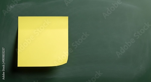 Bright yellow square reminder paper is affixed to a dark green writing surface