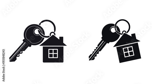 Two black house keys with keychain on white background