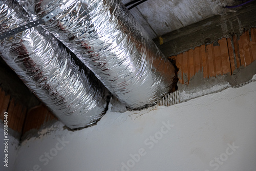 Photos Insulated ventilation ducts passing through wall opening during house construction