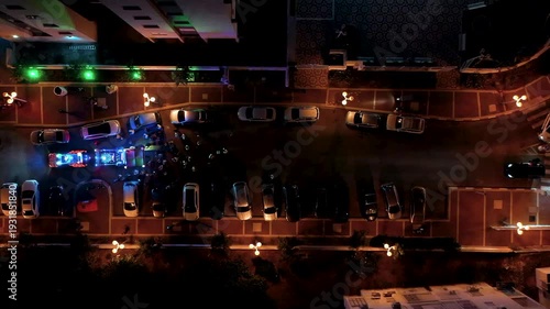 Top down aerial view of a Jewish Torah Scroll procession ceremony with a decorated canopy and crowd at night