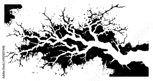 Artistic silhouette of branching tree limbs with black ink splatters and paint drips