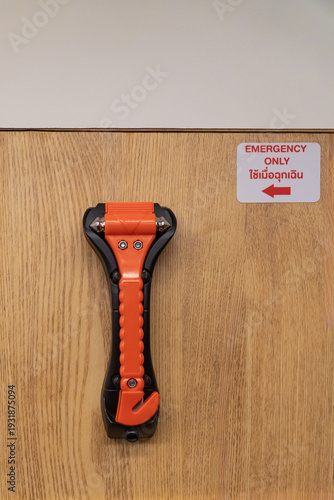 Safety glass hammer is used to break window glass for emergency escape, mounted on the wall in train carriages.There is a Thai language which means emergency only.
