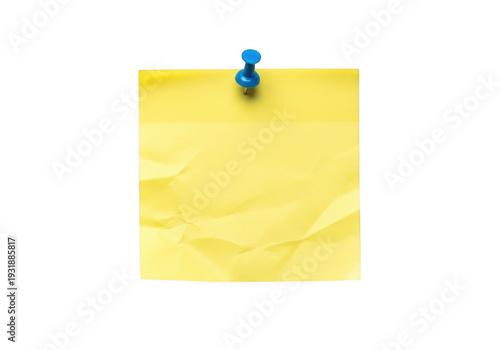 A yellow sticky note pinned to a surface with a blue thumbtack