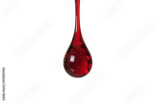 Vibrant red liquid droplet falling in mid-air