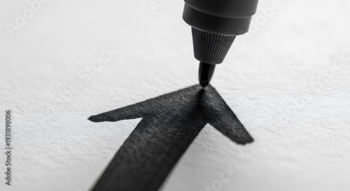 Black Pen Drawing Arrow on White Paper.