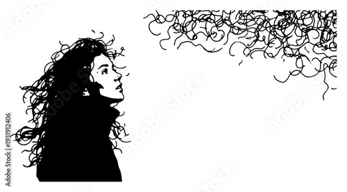 Artistic silhouette of a woman with long curly hair looking upwards