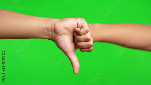 Hand displaying thumbs down gesture in isolated VIDEO on green screen