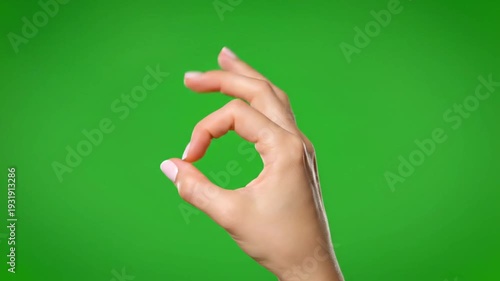 Dynamic VIDEO of presenter hand gesturing OK sign in studio setting