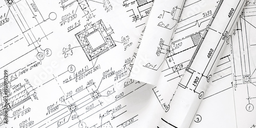 Architectural blueprints with rolled plans and solar panel, sustainable architecture and green building design, renewable energy integration, construction planning backgroun
