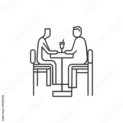 Two People Sitting at a Table with a Drink