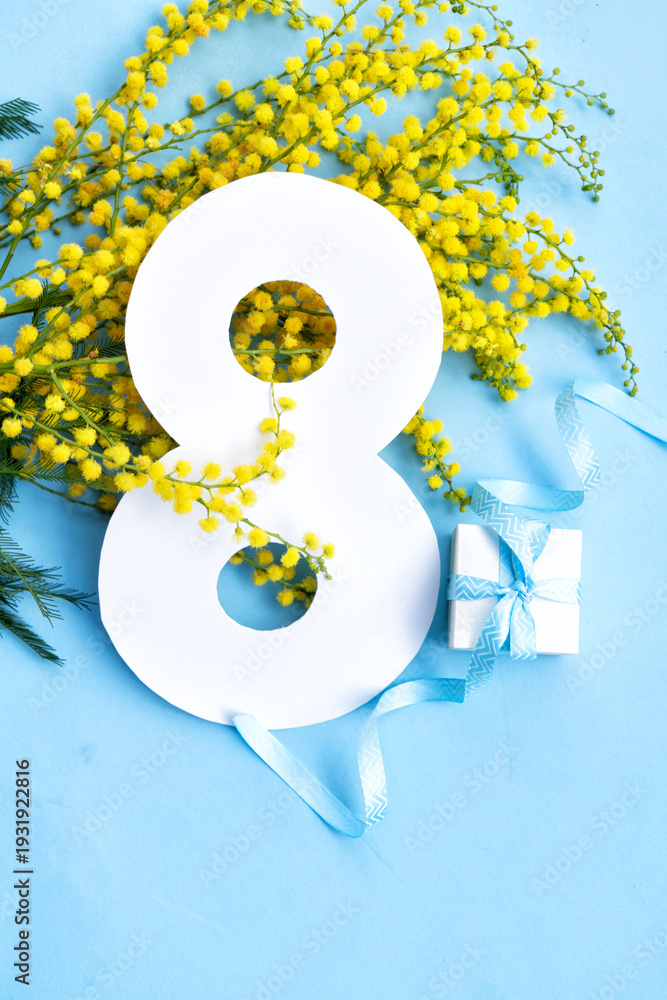 Fototapeta premium Mimosa yellow flowers on blue spring background, 8 march day festive background, mimose is traditional flowers for international womans day 8 of march