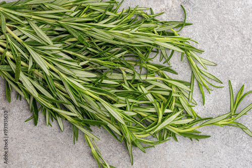 Rosemary branches on the old stone table background	