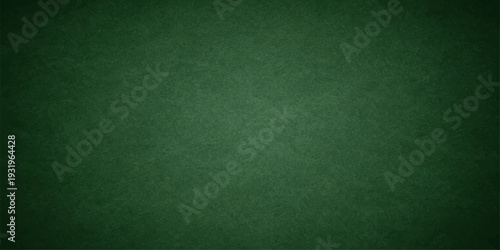 Empty vintage green chalkboard background with a grunge texture and old paper material pattern for a blank wallpaper surface backdrop