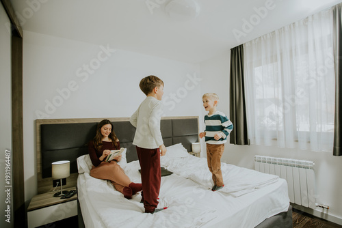 Two boys play and jump on b...