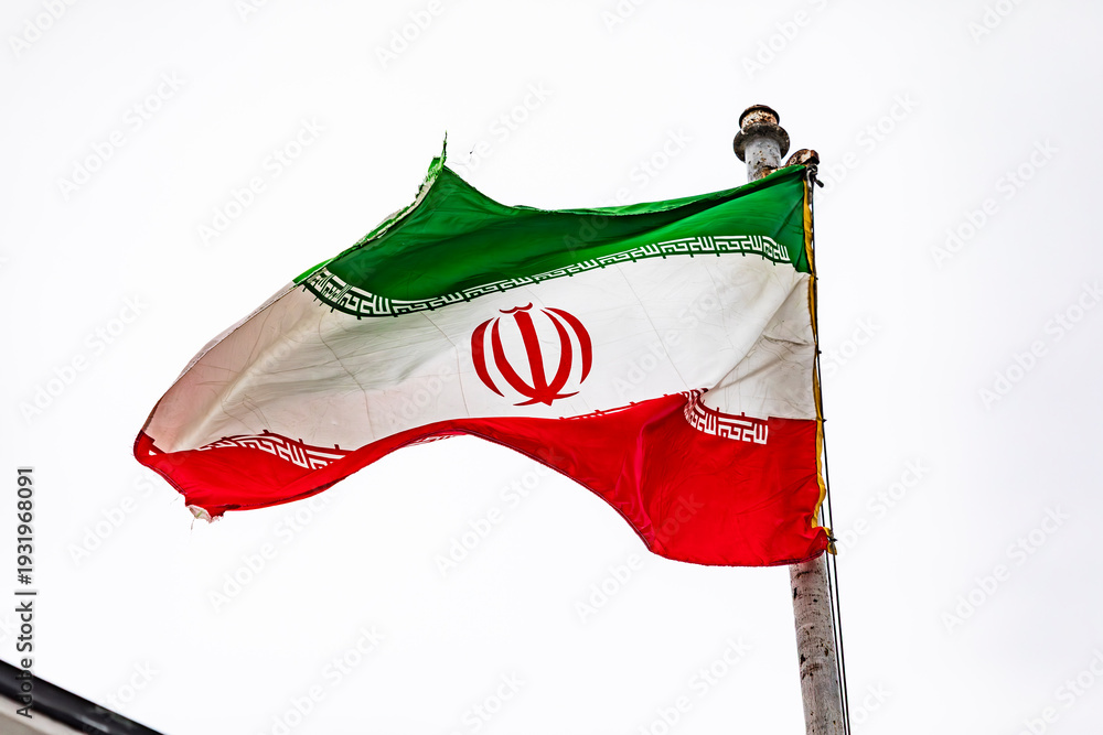 Obraz premium The flag of Iran on the flagpole on the roof of the embassy building