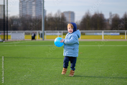 Toddler Playing With Blue Ball
