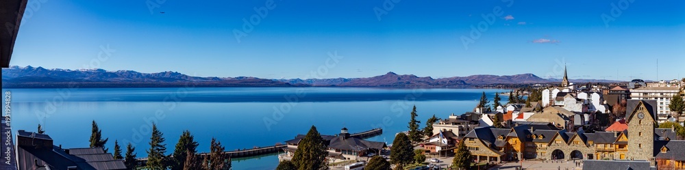 Obraz premium panorama of the lake Bariloche's main square, with Alpine-inspired architecture and the cathedral tower San Carlos de Bariloche, Patagonia, Argentina. Andes Mountains