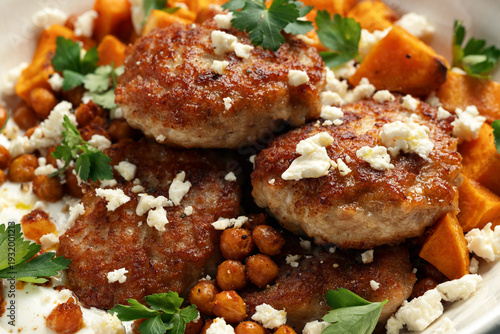 Tableau sur toile Chicken patties with sweet potato, chickpeas, yogurt and feta cheese