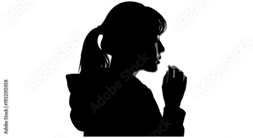 young womans silhouette in profile holds a small pill to her mouth reflecting on a personal health or contemplative moment.