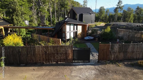 Cabin Modern house with contemporary A-frame architecture, nestled in a lush forest with mountain views and a landscaped garden.