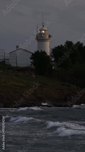 The most important warning for sailors is the lighthouse. The red historical lighthouse in Akyarlar, Bodrum, built in 1931, also showing the directions. Vertical video for social media.