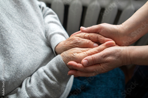 Bild auf Leinwand Elderly woman holding hands with caregiver showing compassion, support and home