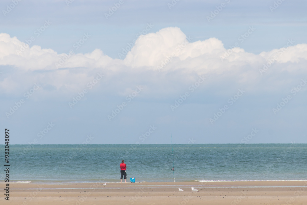 Fototapeta premium La plage du Châtelet à Tardinghen dans le Pas-de-Calais en région Hauts-de-France sur la côte d'opale: silhouette sur la plage en été, homme sur la plage