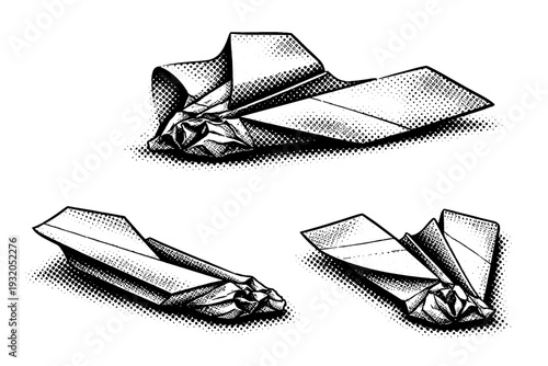 Crashed paper airplane ? compact folded paper airplane shown nose-first crash deformation, asymmetrical wing bend, and flattened profile emphasizing crease