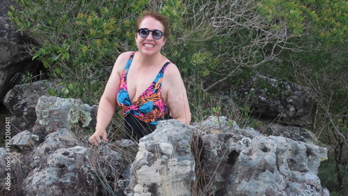 woman sitting on rock