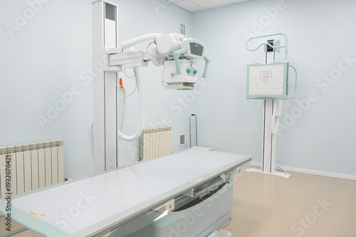Medical X-ray room with imaging equipment and examination table