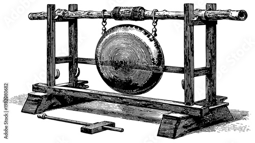 Black and white illustration of a gong suspended on a wooden frame with a mallet