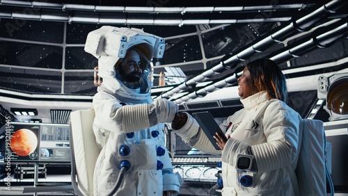 Photos Cosmonaut doing fist bump with colleague, leaving starship to descend on planet during mankind survival expedition