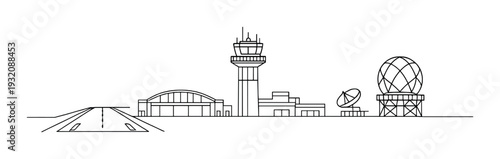 Airport control tower and hangars with runway in foreground