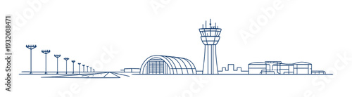 Airport runway lights with hangar and control tower on skyline