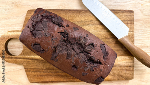 Fotografija Rich chocolate loaf flaunts luscious decadence on rustic board, perfect for Worl