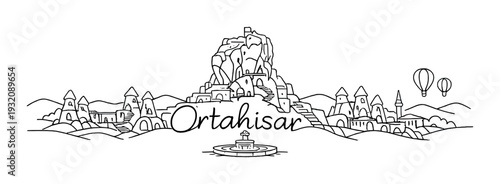 Ortahisar town skyline with rock formation and hot air balloons