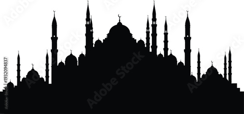 Mosque silhouette at dusk with minarets and domes