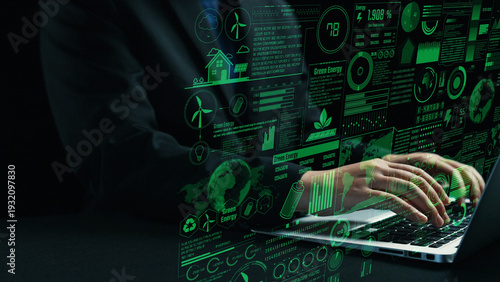 Obraz na plátně A business professional interacts with digital data on a laptop, showcasing graphs and statistics related to green energy and sustainability, highlighting innovation and analysis