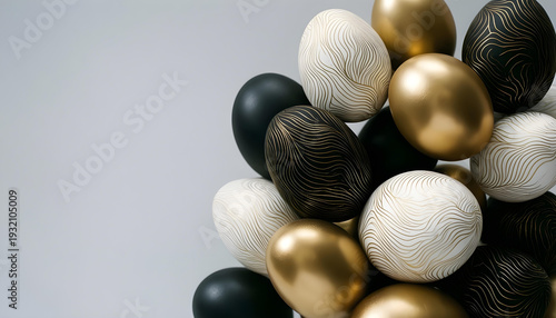 Elegant Easter eggs in gold, black, and white with intricate line patterns piled together