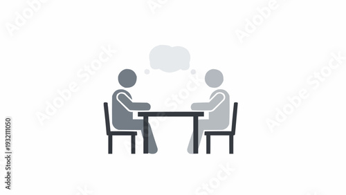 Two People Sitting at Table Discussing.