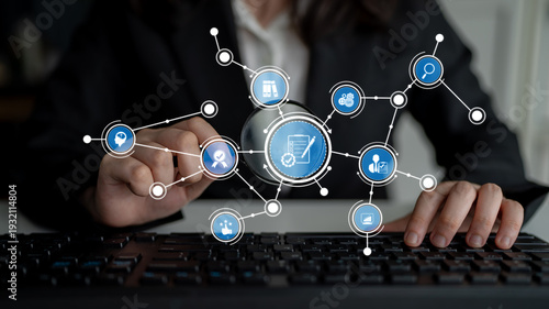 Photos A business professional engages with digital connections and data analytics by navigating a keyboard amidst innovative graphics, showcasing modern technology in the office