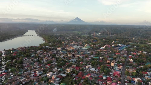 Aerial view of Donsol town at sunset with Mayon Volcano in the distance, Philippines
