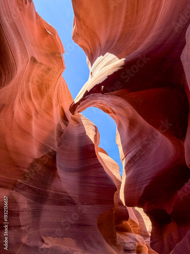 Lower Antelope Canyon in Arizona featuring narrow, winding sandstone passageways with smooth, wave-like rock formations illuminated by soft natural light from above.