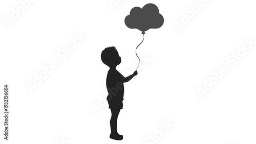 Little boy holding cloud shaped balloon in silhouette